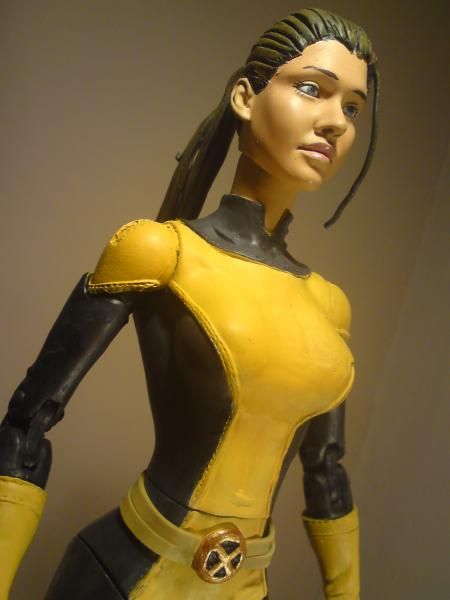 Yellow,Latex clothing,Action figure,Fictional character,Toy,Figurine,Latex,Statue,Spandex